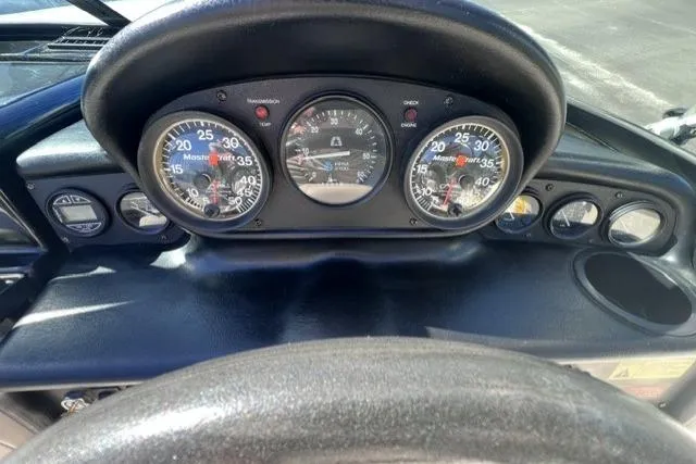 Slide: The Image of Dashboard of a 1996 MasterCraft ProStar 190 boat with gauges and controls. - 14