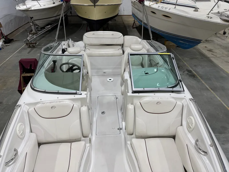 Slide: The Image of Interior view of a 2006 Crownline 220 EX with white leather seats and an open cockpit. - 11