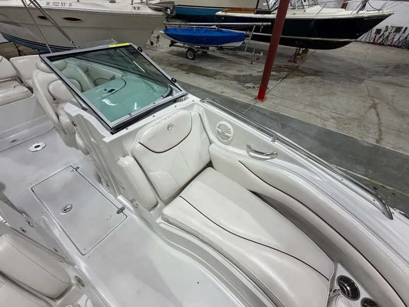 Slide: The Image of The image shows the interior of a 2006 Crownline 220 EX boat with white leather seating. - 10