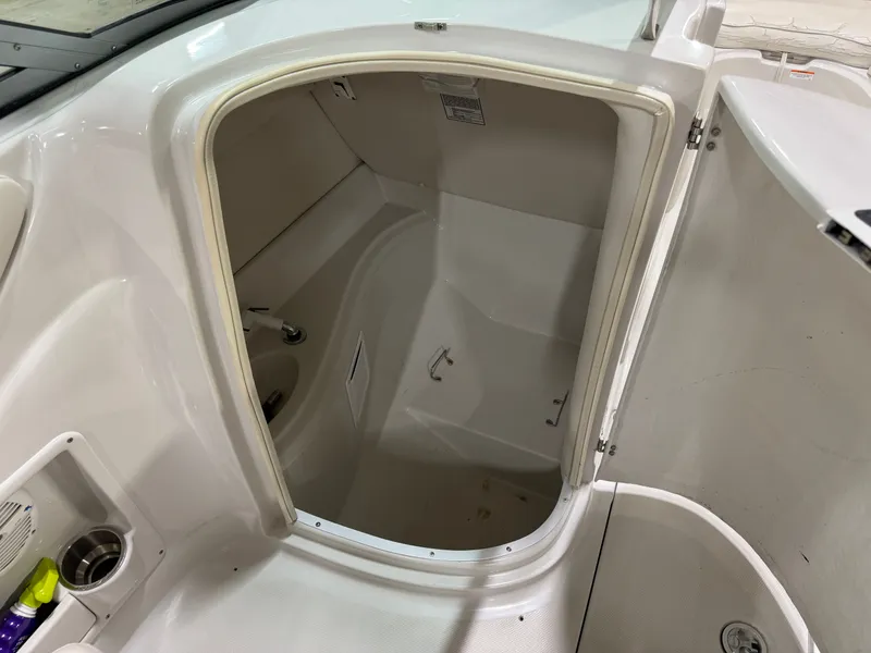 Slide: The Image of The image shows the interior of a 2006 Crownline 220 EX boat with a small cabin. - 16