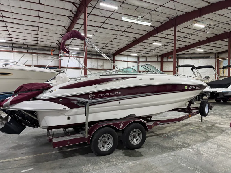 Slide: The Image of A 2006 Crownline 220 EX boat on a trailer inside a storage facility. - 2