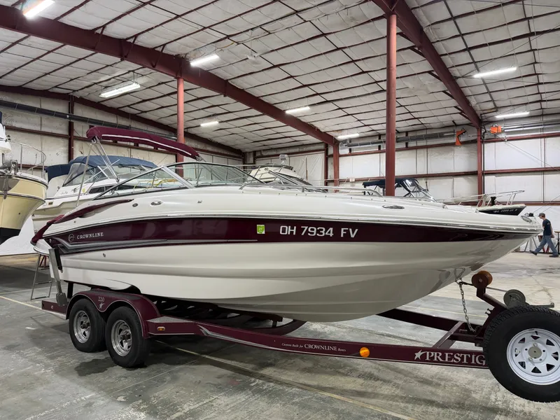 Slide: The Image of A 2006 Crownline 220 EX on a trailer inside a warehouse. - 3