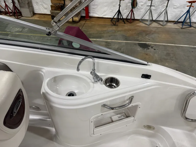 Slide: The Image of The image shows the cockpit of a 2006 Crownline 220 EX with a built-in sink. - 20