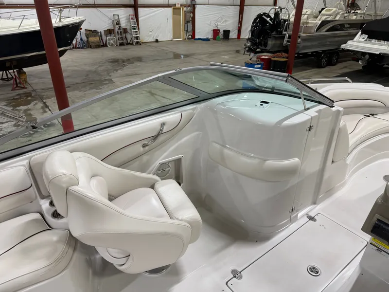 Slide: The Image of The image shows the cockpit of a 2006 Crownline 220 EX boat with white leather seats. - 15
