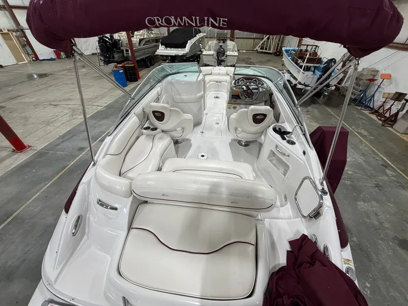 Slide: The Image of The image shows a 2006 Crownline 220 EX boat with white and burgundy seating. - 5