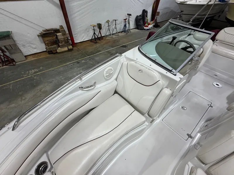 Slide: The Image of The image shows the cockpit of a 2006 Crownline 220 EX boat with white leather seats. - 9