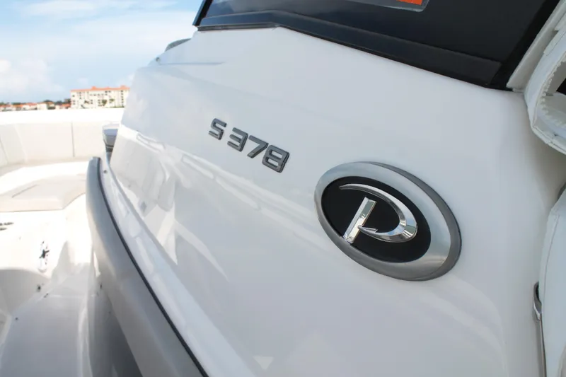 Slide: The Image of 2023 Pursuit S 378 Sport boat, sleek white exterior with logo and model name. - 34