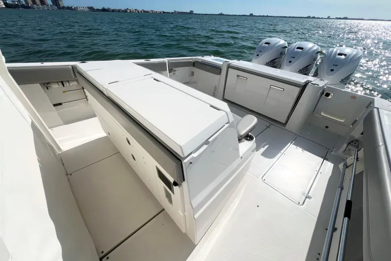 Slide: The Image of 2023 Pursuit S 378 Sport boat deck with triple outboard engines on water. - 16