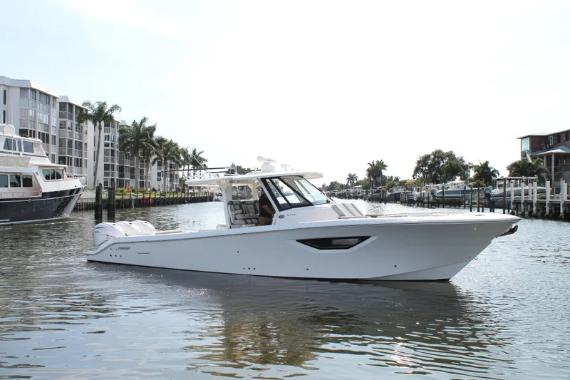 The Image of 2023 Pursuit S 378 Sport boat cruising in a scenic waterfront setting. - 0