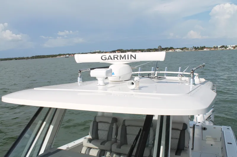 Slide: The Image of 2023 Pursuit S 378 Sport boat with Garmin radar on calm waters. - 40