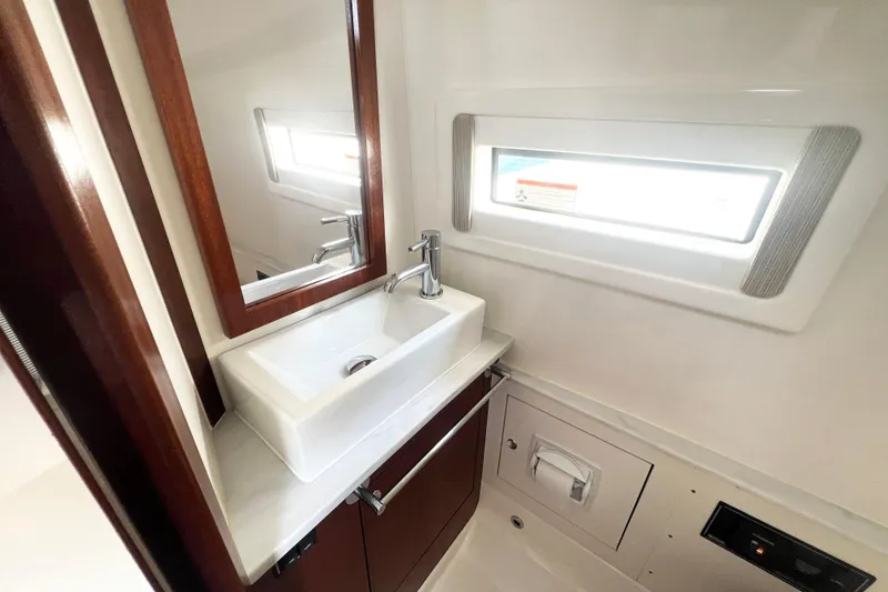 Slide: The Image of 2023 Pursuit S 378 Sport yacht bathroom with sink, mirror, and window. - 56