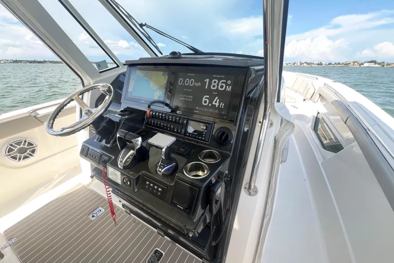 Slide: The Image of 2023 Pursuit S 378 Sport boat cockpit with advanced navigation and control systems. - 37