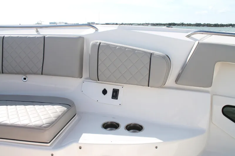 Slide: The Image of 2023 Pursuit S 378 Sport boat interior with quilted seating and cup holders. - 46