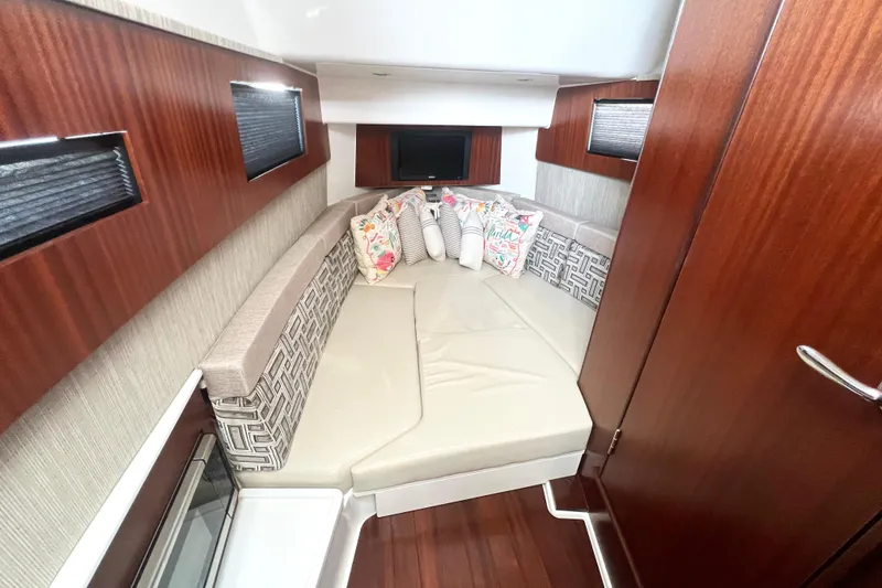 Slide: The Image of Luxurious cabin interior of 2023 Pursuit S 378 Sport boat with plush seating and cushions. - 53