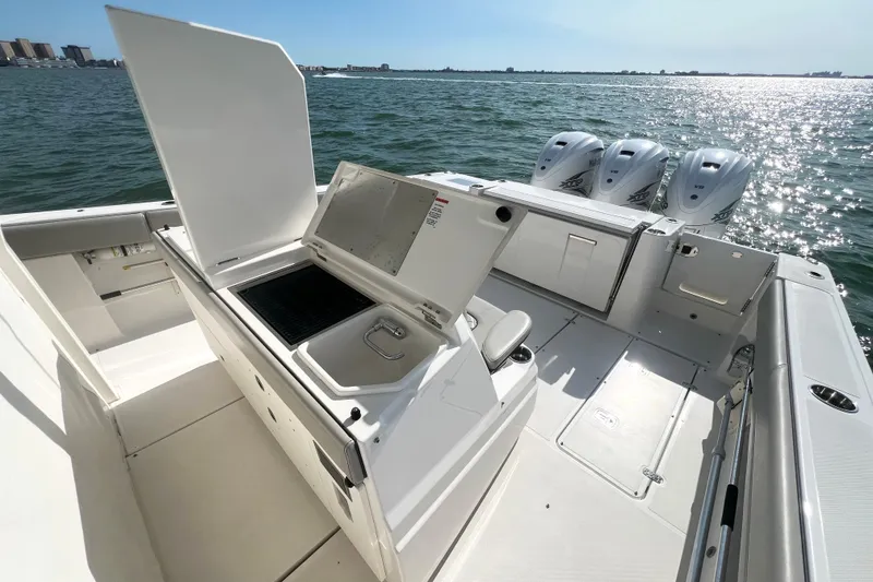 Slide: The Image of 2023 Pursuit S 378 Sport boat with open deck and triple outboard engines. - 17