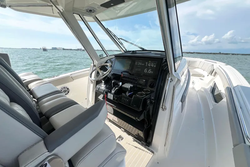 Slide: The Image of 2023 Pursuit S 378 Sport boat interior with advanced navigation system and luxurious seating. - 28