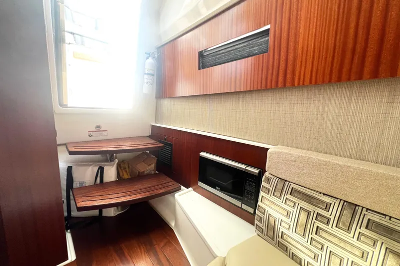 Slide: The Image of Interior of 2023 Pursuit S 378 Sport boat with wooden accents and modern amenities. - 54