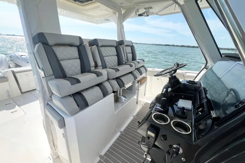 Slide: The Image of 2023 Pursuit S 378 Sport boat interior with luxurious seating and modern helm controls. - 29