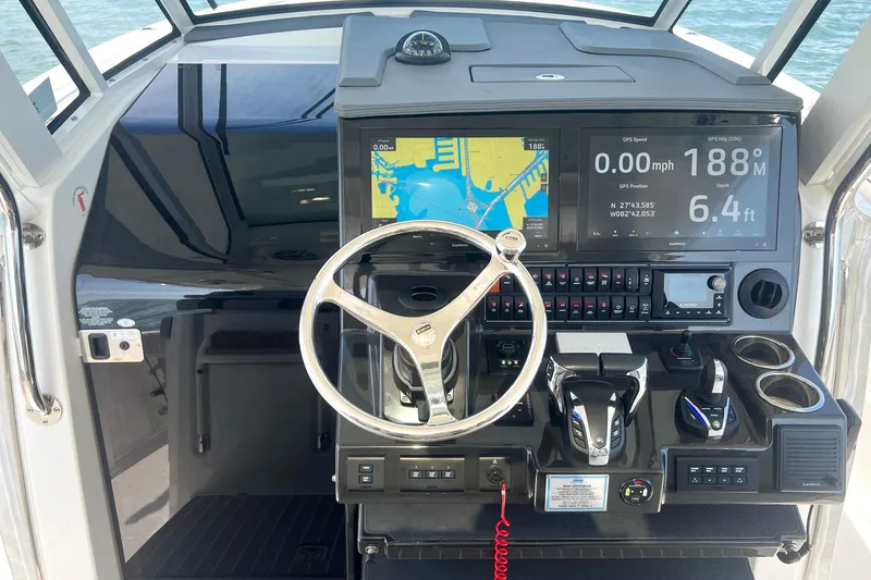 Slide: The Image of Helm of 2023 Pursuit S 378 Sport boat with advanced navigation displays and controls. - 36