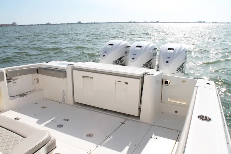 Slide: The Image of 2023 Pursuit S 378 Sport boat with triple Yamaha engines on open water. - 14