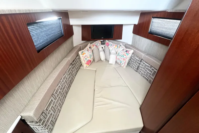 Slide: The Image of Luxurious cabin interior of 2023 Pursuit S 378 Sport boat with plush seating and decorative pillows. - 52