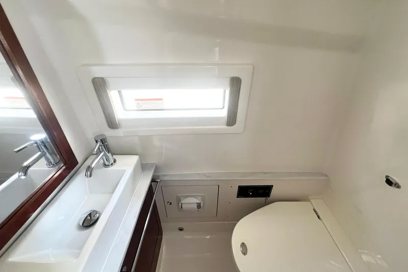 Slide: The Image of 2023 Pursuit S 378 Sport boat bathroom with sink, toilet, and window. - 57
