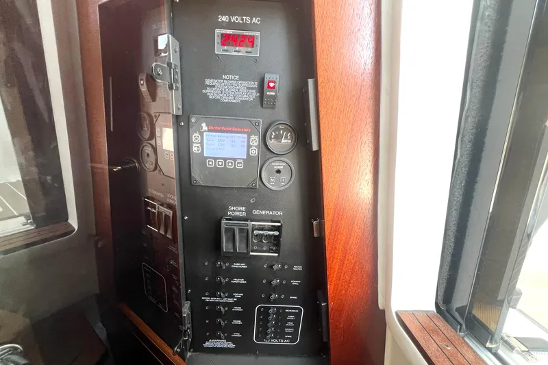 Slide: The Image of Electrical control panel on 2023 Pursuit S 378 Sport boat, featuring generator and power switches. - 51