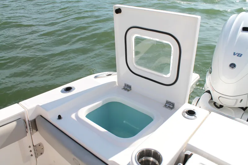 Slide: The Image of 2023 Pursuit S 378 Sport boat with open storage compartment and V8 engine on water. - 21
