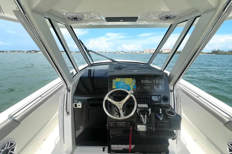 Slide: The Image of 2023 Pursuit S 378 Sport boat dashboard with navigation display on open water. - 35