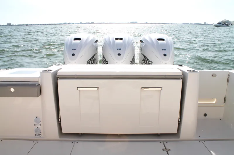 Slide: The Image of 2023 Pursuit S 378 Sport boat with triple V8 engines on open water. - 19