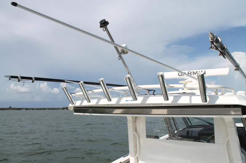Slide: The Image of 2023 Pursuit S 378 Sport boat with fishing rod holders and Garmin equipment on open water. - 38