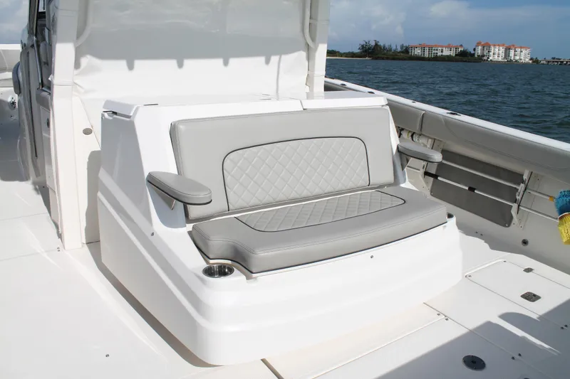 Slide: The Image of 2023 Pursuit S 378 Sport boat interior with cushioned seating and ocean view. - 26