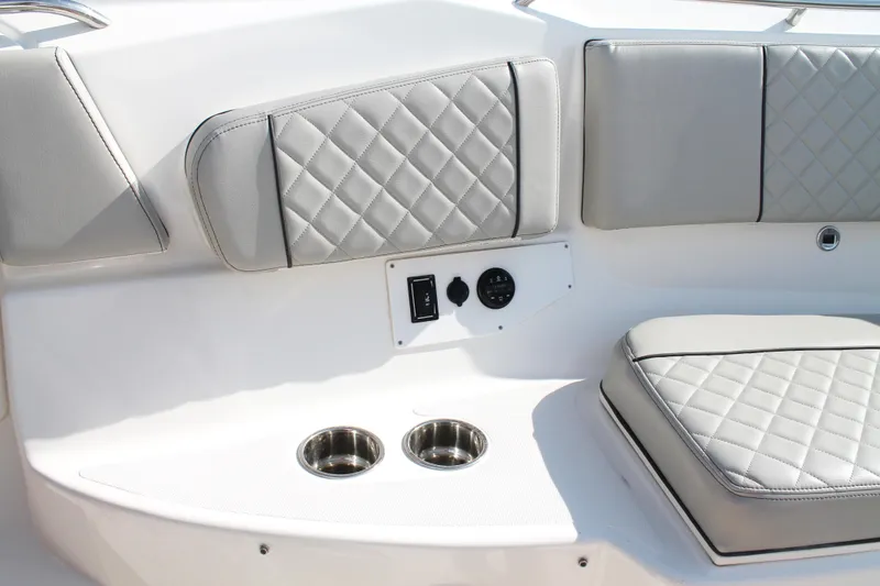 Slide: The Image of 2023 Pursuit S 378 Sport boat interior with quilted seating and cup holders. - 48