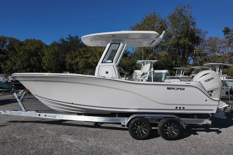 Slide: The Image of 2026 Sea Fox 228 Commander boat on trailer, side view, outdoors. - 1