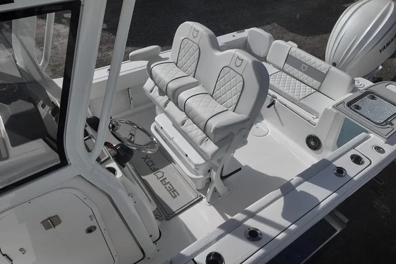 Slide: The Image of 2026 Sea Fox 248 Commander boat interior with white seating and steering console. - 11