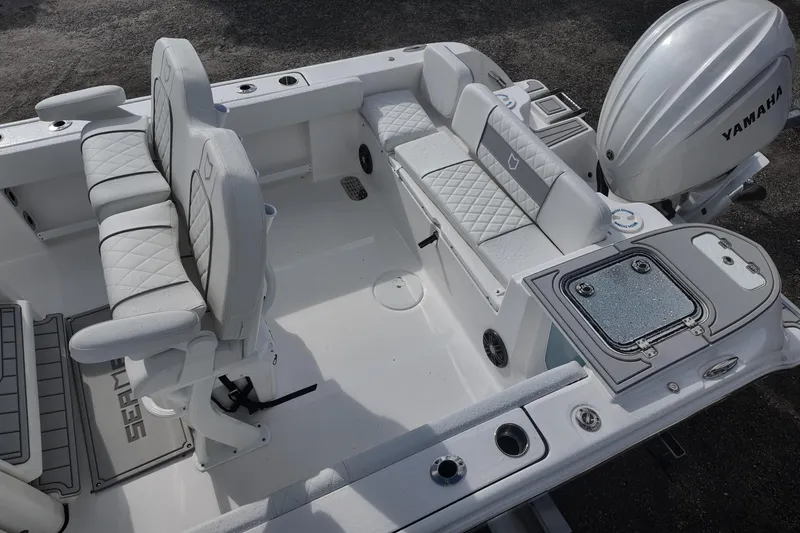 Slide: The Image of 2026 Sea Fox 248 Commander boat interior with Yamaha engine, featuring cushioned seating and storage. - 12