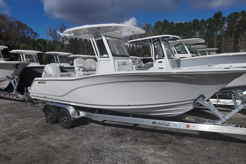 The Image of 2026 Sea Fox 248 Commander boat on trailer, parked outdoors under cloudy sky. - 0