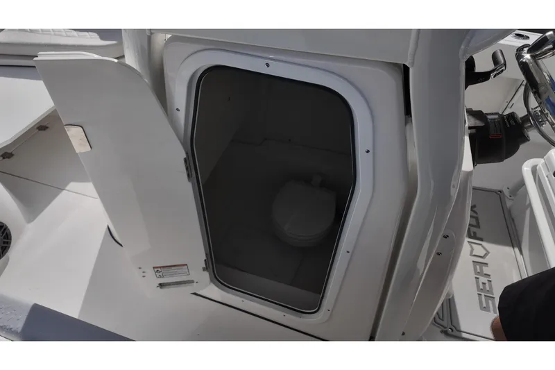 Slide: The Image of 2026 Sea Fox 248 Commander boat interior with open cabin door showing toilet. - 10