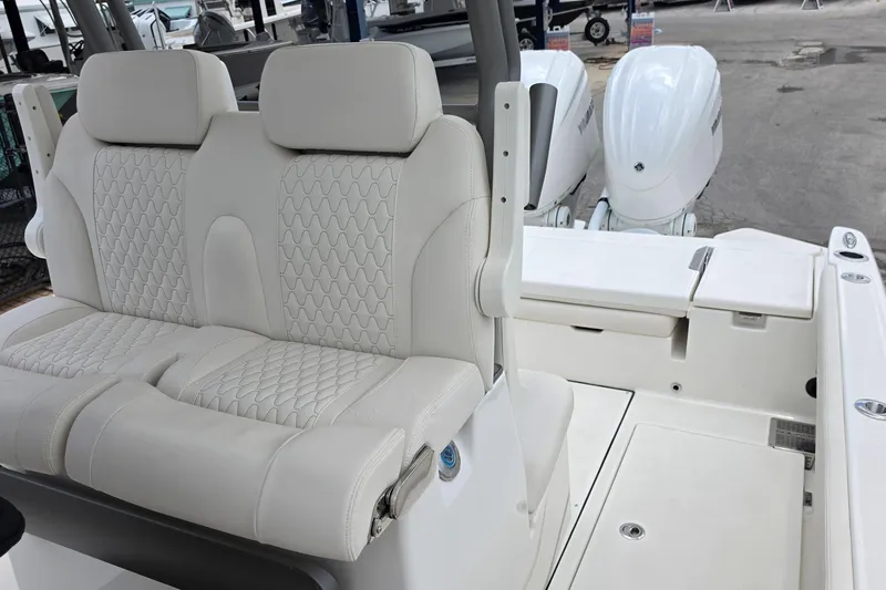 Slide: The Image of 2027 Solace 28HCS boat interior with plush seating and dual outboard engines. - 22