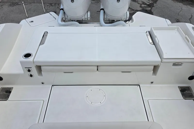 Slide: The Image of 2027 Solace 28HCS boat deck with storage compartments and dual outboard motors. - 11