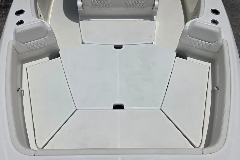 Slide: The Image of Spacious seating area of 2027 Solace 28HCS boat with cushioned seats and storage compartments. - 20