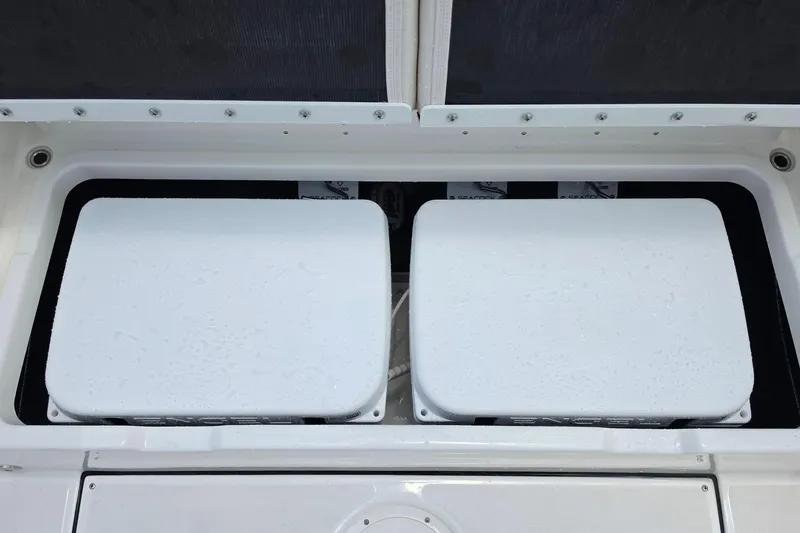 Slide: The Image of Storage compartment of 2027 Solace 28HCS boat with two white lids. - 13