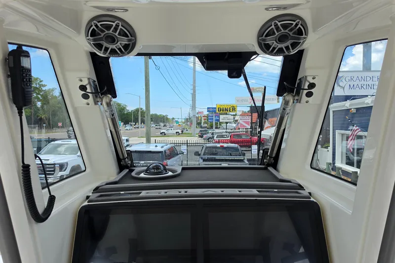 Slide: The Image of Interior view of 2027 Solace 28HCS boat cockpit with speakers and navigation equipment. - 15