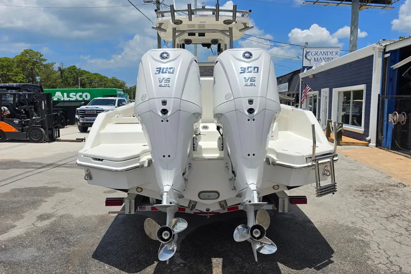 Slide: The Image of 2027 Solace 28HCS boat with twin Yamaha 300 V6 outboard engines at a marina. - 4