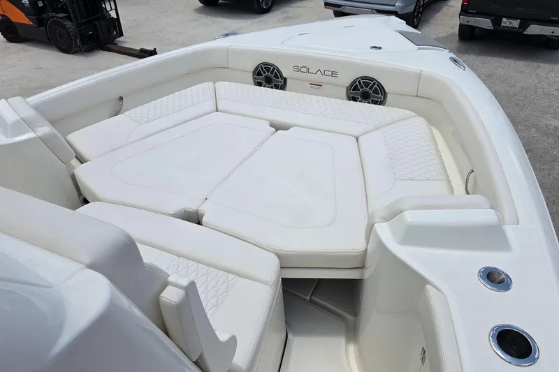 Slide: The Image of Luxurious seating area on a 2027 Solace 28HCS boat, featuring white cushioned seats. - 18