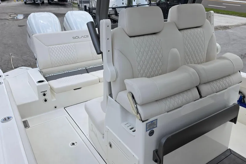 Slide: The Image of Luxurious seating on a 2027 Solace 28HCS boat with dual engines in the background. - 21