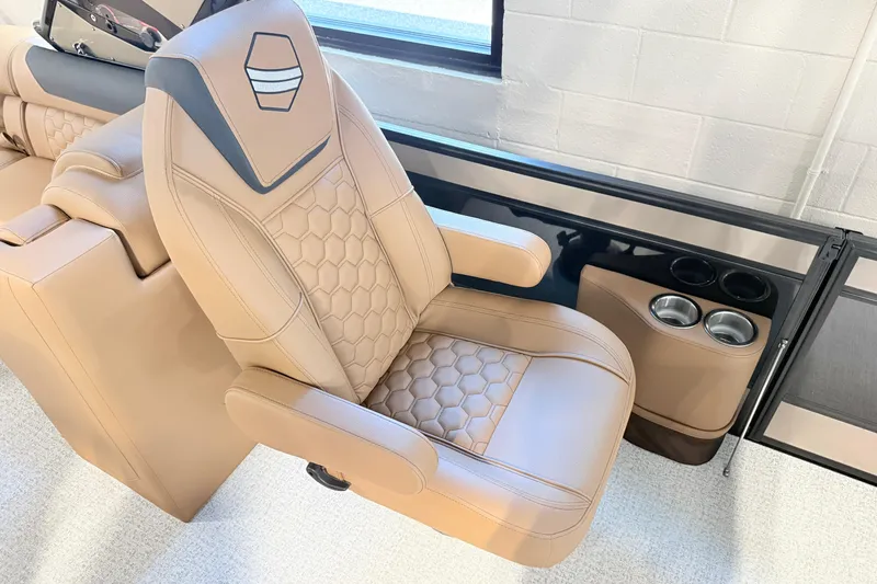 Slide: The Image of Luxurious tan seating in 2026 South Bay 525RS DC boat with cup holders. - 3