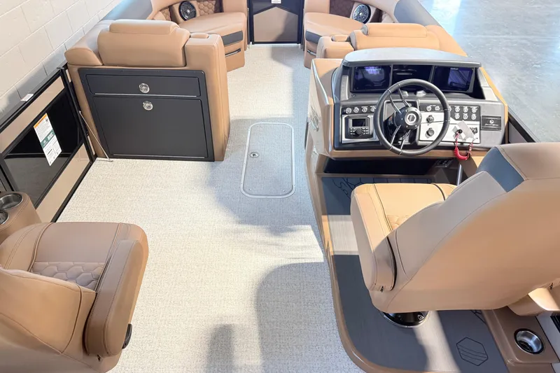 Slide: The Image of 2026 South Bay 525RS DC boat interior with luxurious tan seating and modern dashboard controls. - 14