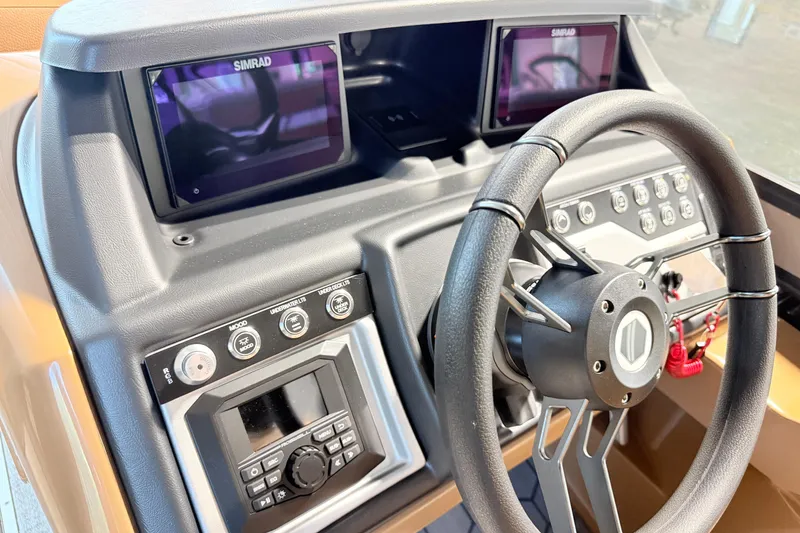 Slide: The Image of 2026 South Bay 525RS DC dashboard with steering wheel and dual Simrad displays. - 17