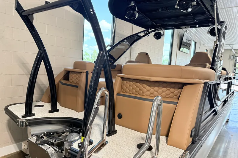 Slide: The Image of 2026 South Bay 525RS DC boat with tan seating and sleek black framework. - 9